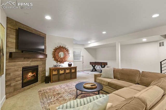 carpeted living area featuring recessed lighting, a fireplace, and baseboards