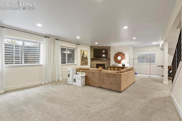 living room featuring a large fireplace, light carpet, baseboards, and recessed lighting