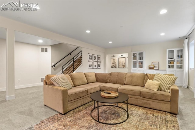 carpeted living room with recessed lighting, stairway, and baseboards