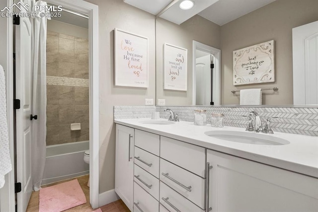 full bath with double vanity, toilet, shower / bathtub combination with curtain, tile patterned floors, and baseboards