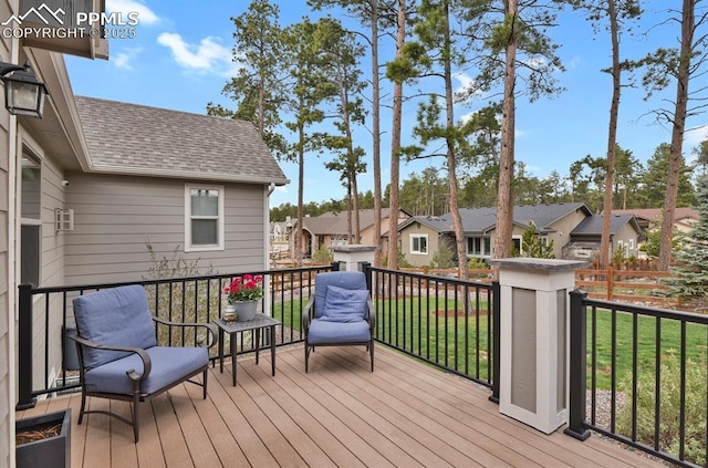 wooden terrace with a residential view and a lawn