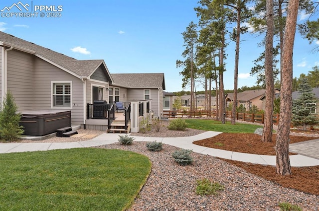 view of yard featuring a hot tub and a deck