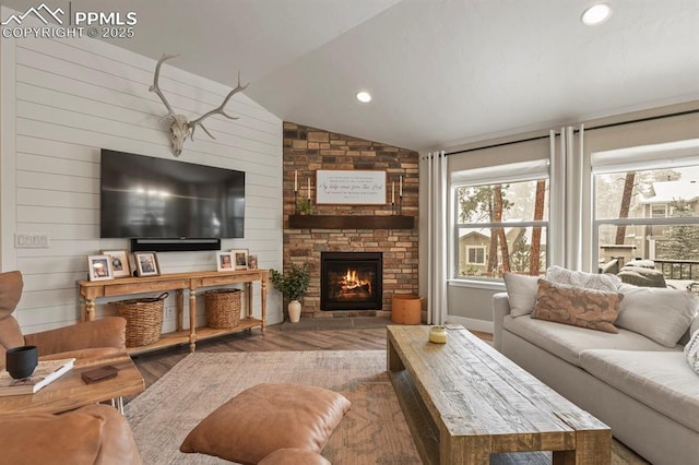 living room featuring vaulted ceiling, wood finished floors, and a fireplace