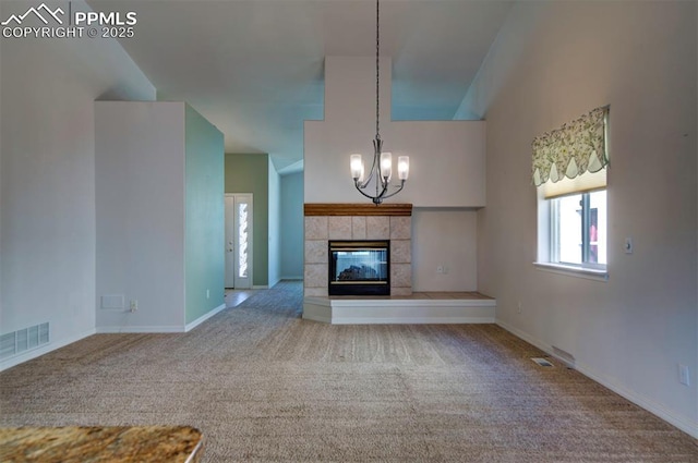 1670 Pinon Glen Cir, Colorado Springs, CO 80919 - unfurnished living room featuring carpet, a chandelier, a tile fireplace, and baseboards