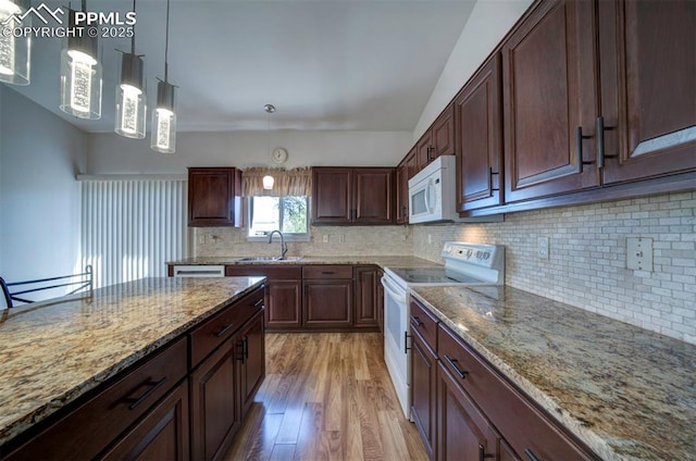 1670 Pinon Glen Cir, Colorado Springs, CO 80919 - kitchen featuring white appliances, a sink, light wood finished floors, tasteful backsplash, and light stone countertops