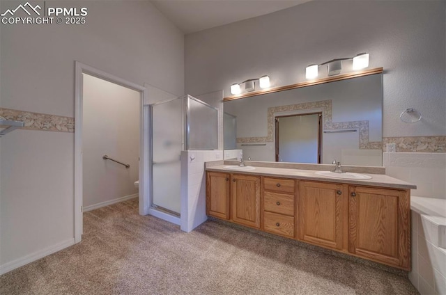 1670 Pinon Glen Cir, Colorado Springs, CO 80919 - bathroom with a stall shower, double vanity, toilet, and tile walls
