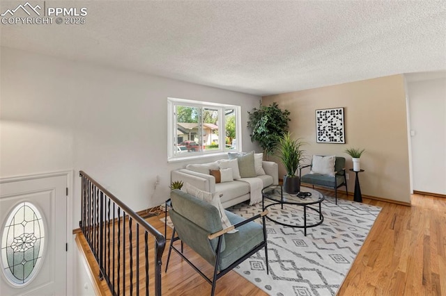 514 Dexter St, Colorado Springs, CO 80911 - living area featuring wood finished floors and a textured ceiling