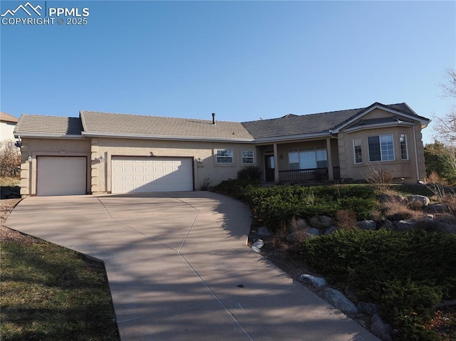 ranch-style home featuring an attached garage, driveway, a tile roof, and stucco siding