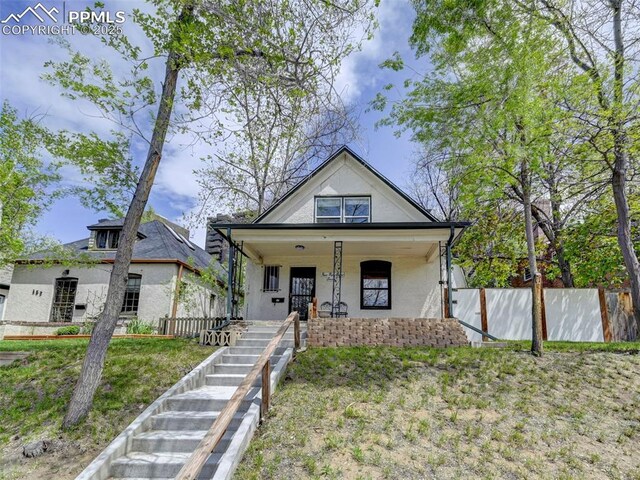 458 S Downing St, Denver, CO 80209 - view of front of property featuring stucco siding, a porch, fence, and stairs