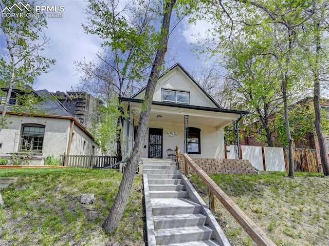 458 S Downing St, Denver, CO 80209 - view of front of home with stucco siding, fence, stairway, and covered porch