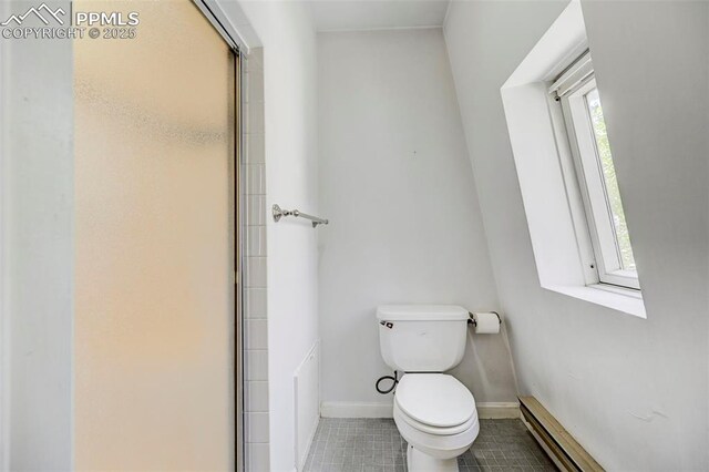 458 S Downing St, Denver, CO 80209 - bathroom with tile patterned flooring, toilet, a baseboard radiator, and baseboards