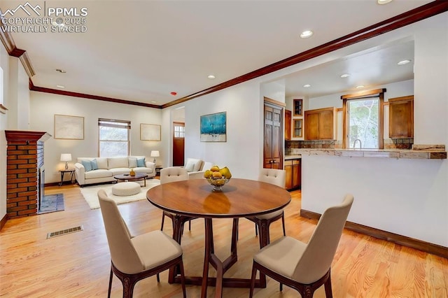 458 S Downing St, Denver, CO 80209 - dining room with plenty of natural light, ornamental molding, light wood-type flooring, recessed lighting, and baseboards