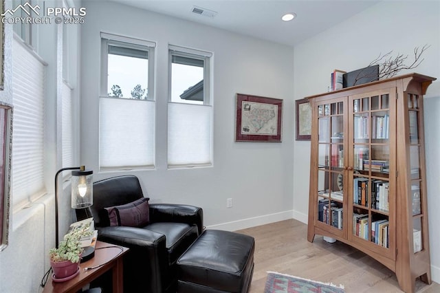 living area with wood finished floors and baseboards