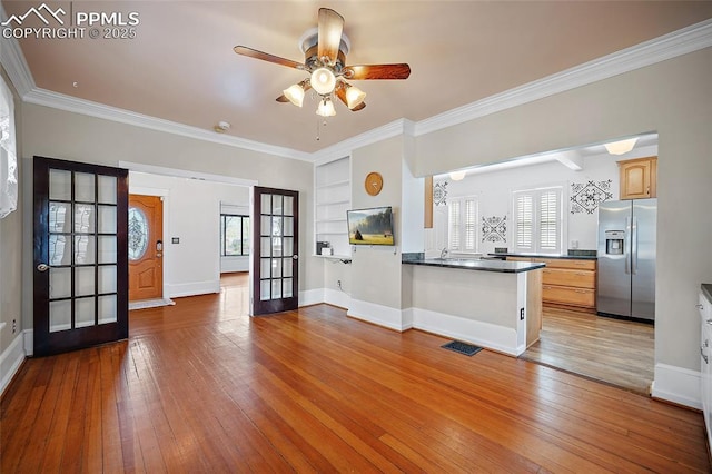 806 E Platte Ave, Colorado Springs, CO 80903 - kitchen with stainless steel fridge, wood-type flooring, ceiling fan, dark countertops, and ornamental molding