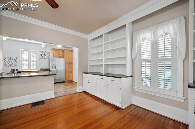 806 E Platte Ave, Colorado Springs, CO 80903 - kitchen featuring stainless steel refrigerator with ice dispenser, open shelves, dark countertops, light wood-type flooring, and ornamental molding