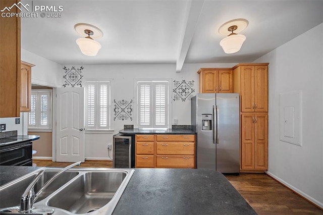806 E Platte Ave, Colorado Springs, CO 80903 - kitchen featuring stainless steel fridge with ice dispenser, beverage cooler, dark countertops, dark wood finished floors, and a sink