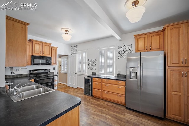 806 E Platte Ave, Colorado Springs, CO 80903 - kitchen with black appliances, a sink, wine cooler, dark countertops, and wood finished floors