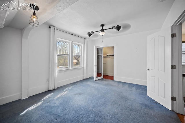 806 E Platte Ave, Colorado Springs, CO 80903 - unfurnished bedroom featuring carpet floors, arched walkways, baseboards, and ceiling fan
