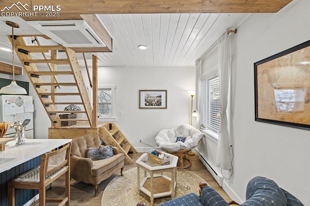 806 E Platte Ave, Colorado Springs, CO 80903 - living area with a baseboard heating unit, wood finished floors, wooden ceiling, and healthy amount of natural light