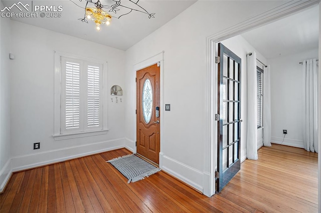 806 E Platte Ave, Colorado Springs, CO 80903 - entryway with a chandelier, baseboards, and hardwood / wood-style flooring