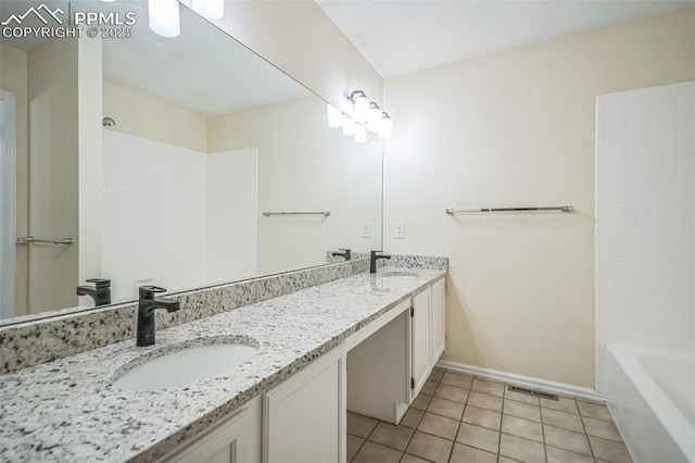 full bathroom featuring tile patterned flooring, baseboards, and double vanity
