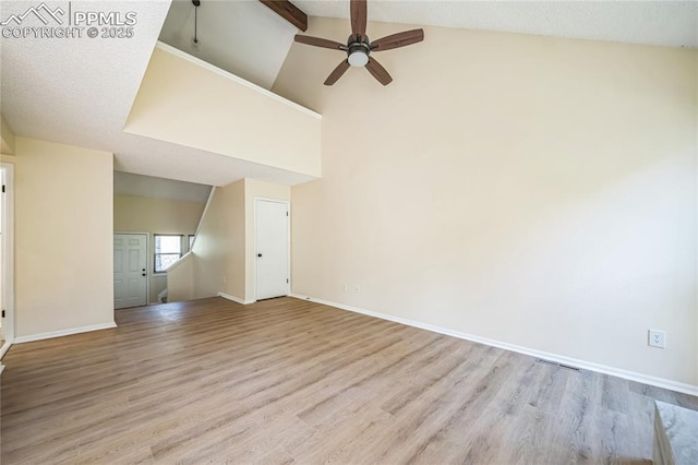 unfurnished room featuring a ceiling fan, wood finished floors, baseboards, beam ceiling, and high vaulted ceiling