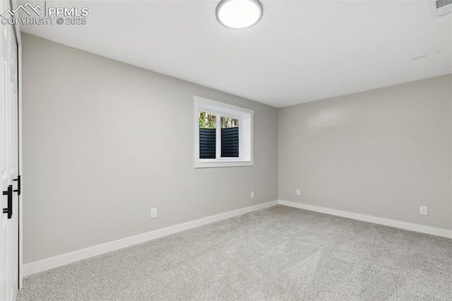 carpeted spare room with baseboards