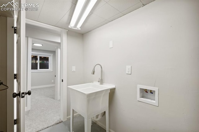 laundry room with washer hookup, baseboards, and carpet floors