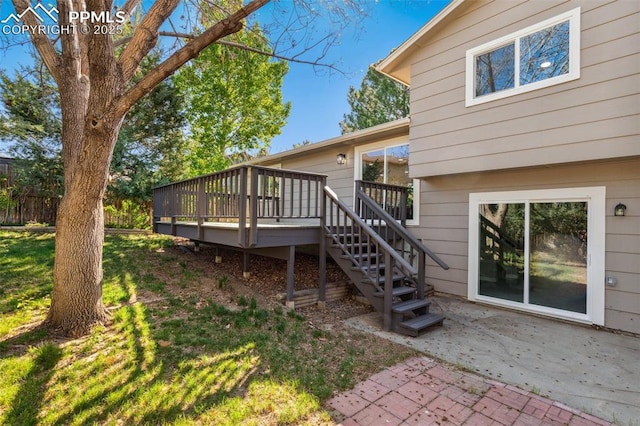 back of house with a wooden deck, a patio area, stairway, and fence