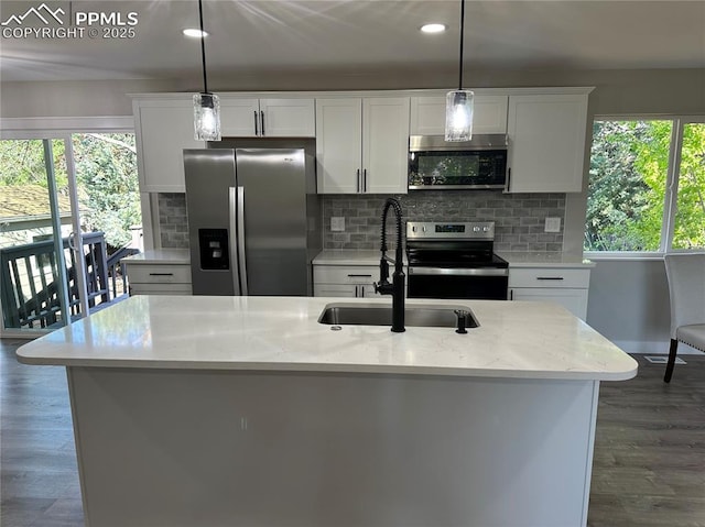 kitchen with stainless steel appliances, a sink, white cabinetry, dark wood-style floors, and recessed lighting