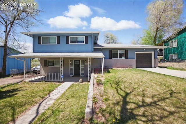 1636 Shenandoah Dr, Colorado Springs, CO 80910 - view of front of house with driveway, covered porch, an attached garage, brick siding, and a front yard