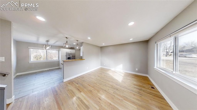 1636 Shenandoah Dr, Colorado Springs, CO 80910 - unfurnished living room featuring light wood finished floors, baseboards, and recessed lighting