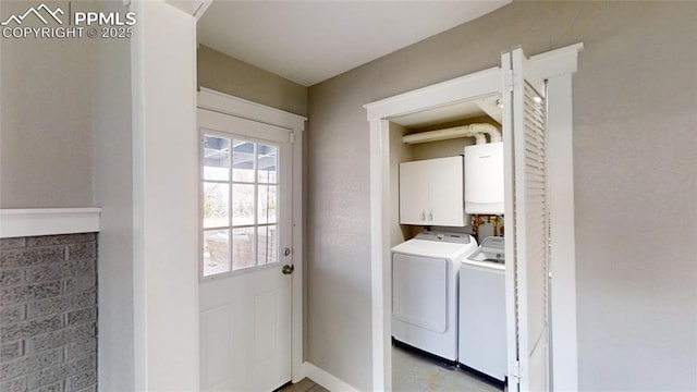 1636 Shenandoah Dr, Colorado Springs, CO 80910 - laundry area featuring washer and dryer, cabinet space, water heater, and baseboards