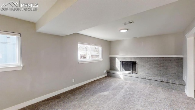 1636 Shenandoah Dr, Colorado Springs, CO 80910 - unfurnished living room featuring a brick fireplace, carpet floors, and baseboards