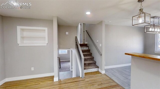 1636 Shenandoah Dr, Colorado Springs, CO 80910 - stairway featuring wood finished floors, baseboards, recessed lighting, and built in features