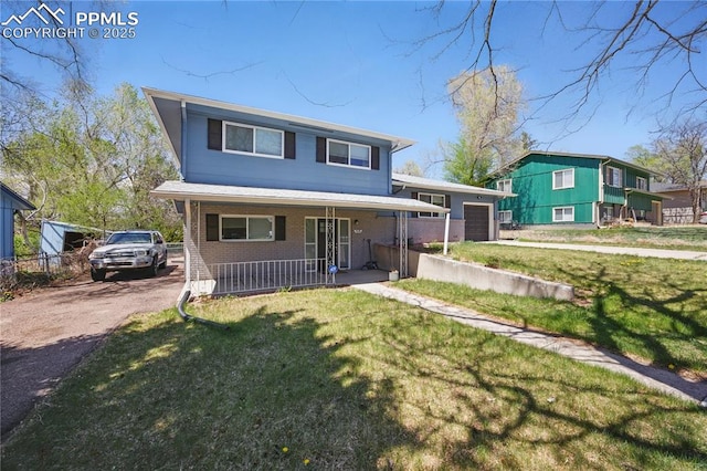 1636 Shenandoah Dr, Colorado Springs, CO 80910 - view of front of home with a porch, brick siding, a front lawn, and asphalt driveway
