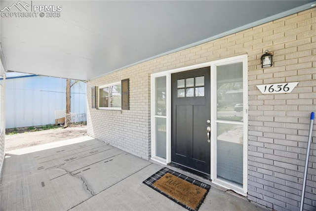 1636 Shenandoah Dr, Colorado Springs, CO 80910 - view of exterior entry with brick siding and a patio