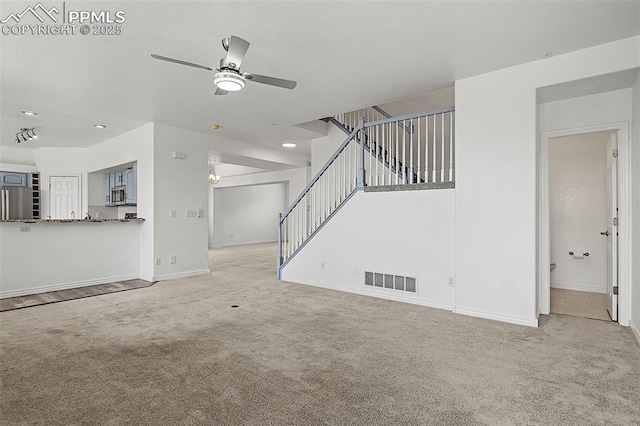 unfurnished living room with carpet flooring, ceiling fan, baseboards, stairway, and recessed lighting
