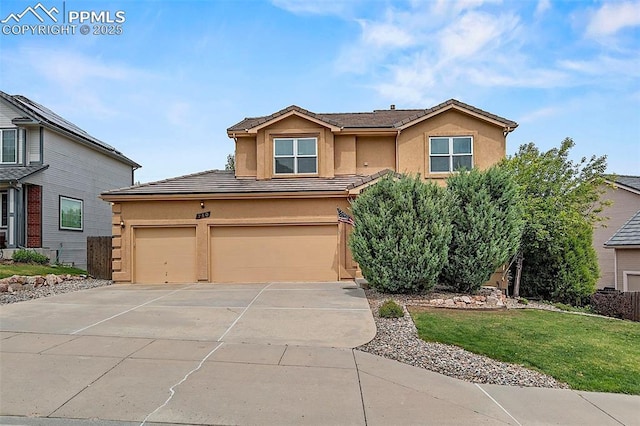 view of front of property with stucco siding, driveway, a front lawn, and a garage