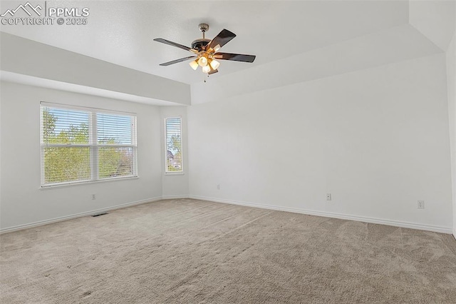 carpeted empty room featuring healthy amount of natural light, a ceiling fan, and baseboards