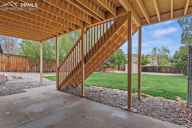 view of patio featuring a storage unit, an outdoor structure, and stairway