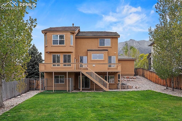 back of property featuring stairs, a deck with mountain view, and stucco siding