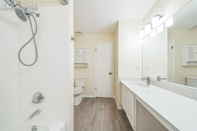 full bathroom with toilet, wood finished floors, shower / bathtub combination, and vanity
