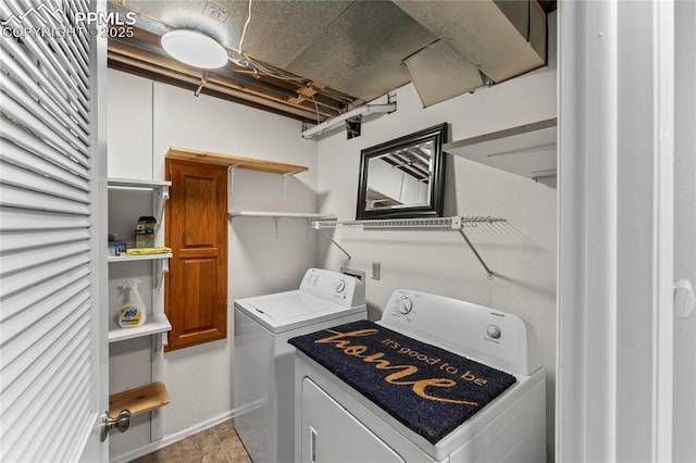 washroom featuring independent washer and dryer and baseboards