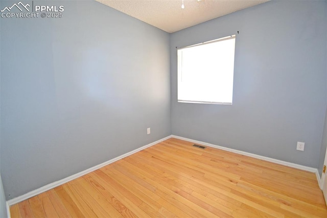 632 Rye Ridge Rd, Fountain, CO 80817 - spare room featuring baseboards, wood finished floors, and a textured ceiling