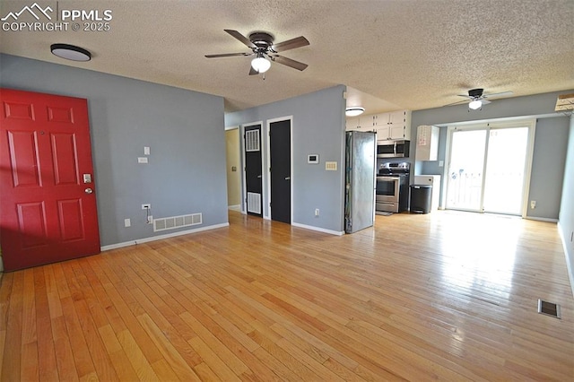 632 Rye Ridge Rd, Fountain, CO 80817 - unfurnished living room with a ceiling fan, a textured ceiling, light wood-type flooring, and baseboards