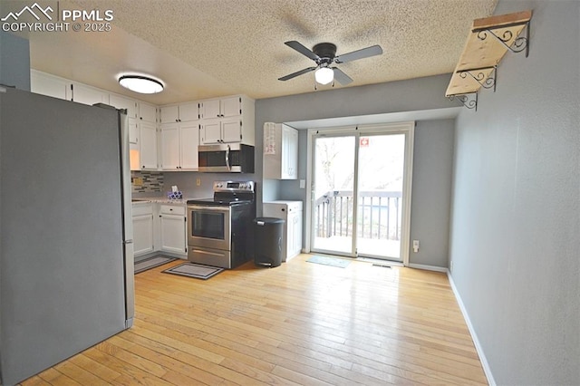 632 Rye Ridge Rd, Fountain, CO 80817 - kitchen featuring appliances with stainless steel finishes, ceiling fan, a textured ceiling, white cabinetry, and light wood-style floors