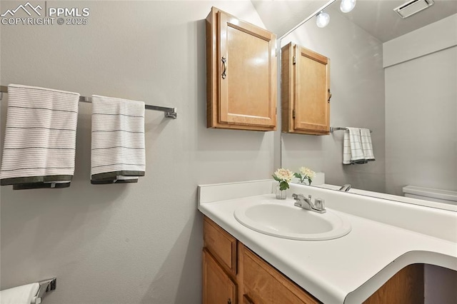 bathroom with vanity and toilet