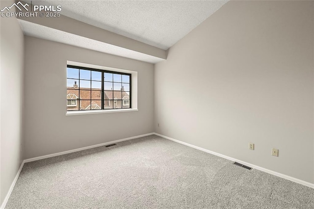 unfurnished room featuring carpet flooring, a textured ceiling, and baseboards