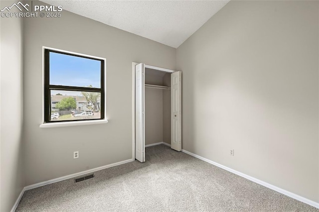 unfurnished bedroom with carpet flooring, baseboards, and a closet